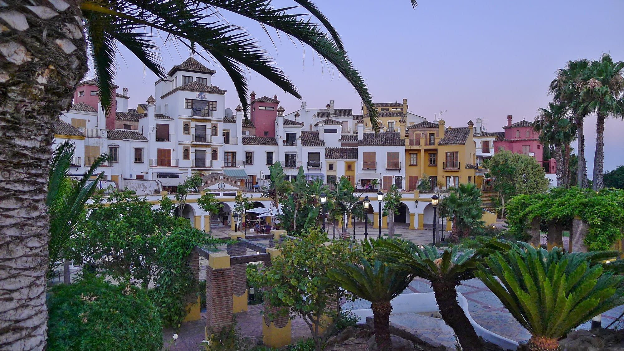 Colourful Andalusian-style buildings around Plaza Loma del Rey in Alcaidesa