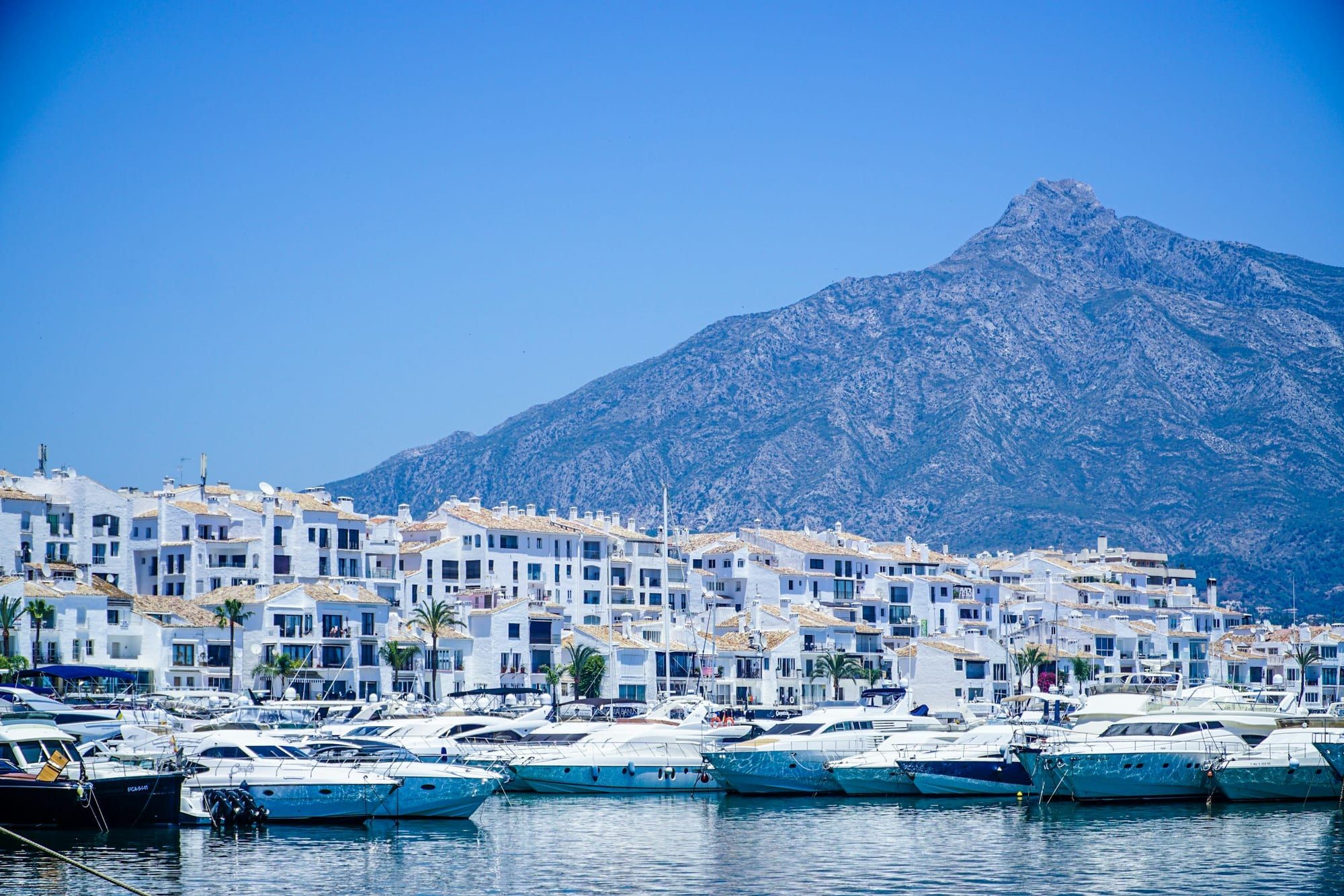 Yachts in a Marbella marina with La Concha mountain behind