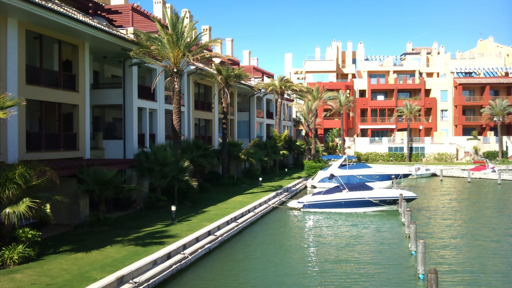 Boats moored along a canal in the Puerto Sotogrande marina